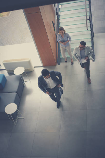 istock Business people ion work. Activity business people running trough building. 825537954