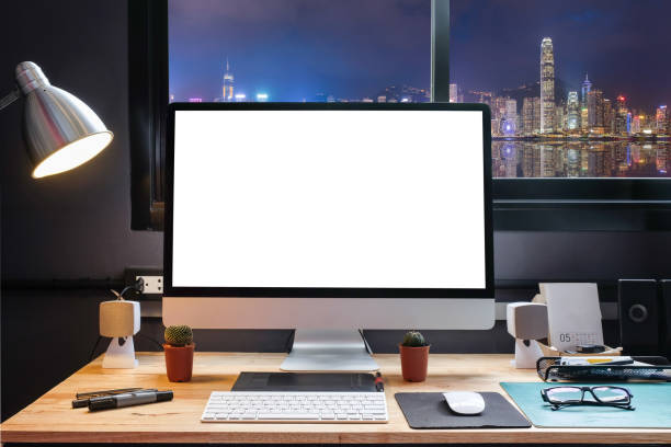 istock Graphic designer's workspace with city night view with a pen tablet, a computer and white background for text 825538412