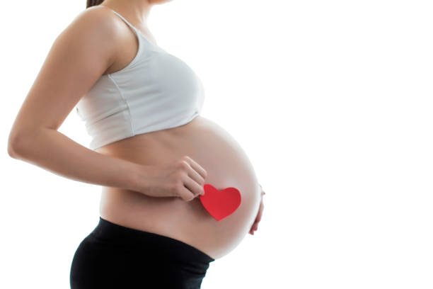 istock Pregnant's woman belly with heart 825538762