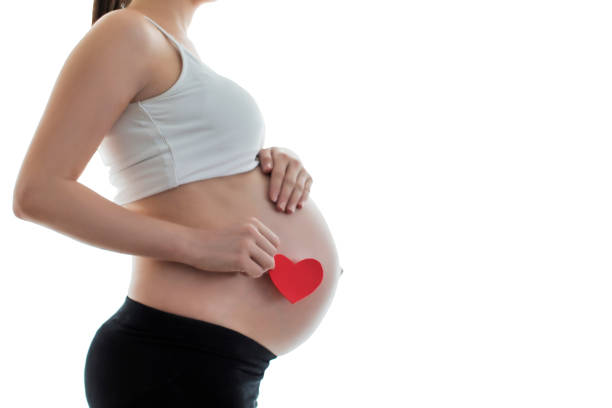 istock Pregnant's woman belly with heart 825538764