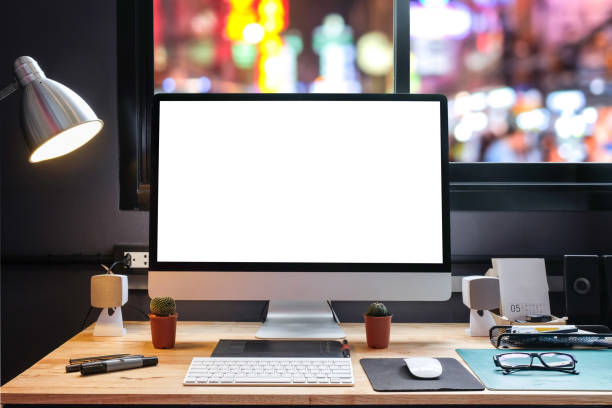 istock Graphic designer's workspace with city night view with a pen tablet, a computer and white background for text 825539078