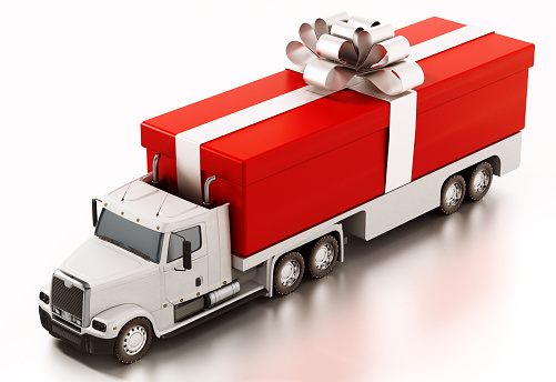 Red giftbox wrapped with gold ribbon loaded at the back of cargo truck.