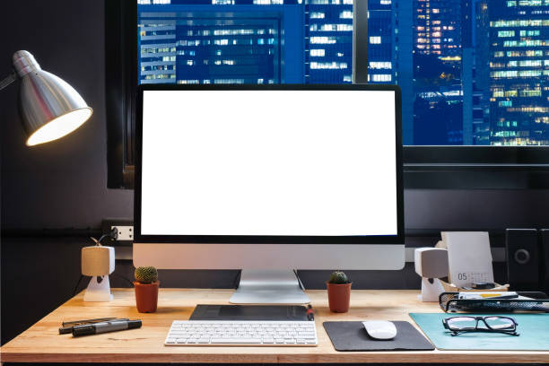 istock Graphic designer's workspace with city night view with a pen tablet, a computer and white background for text 825546376