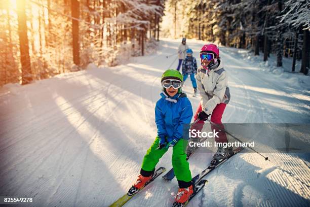 Family Having Fun Skiing Together On Winter Day Stock Photo - Download Image Now - Skiing, Family, Ski