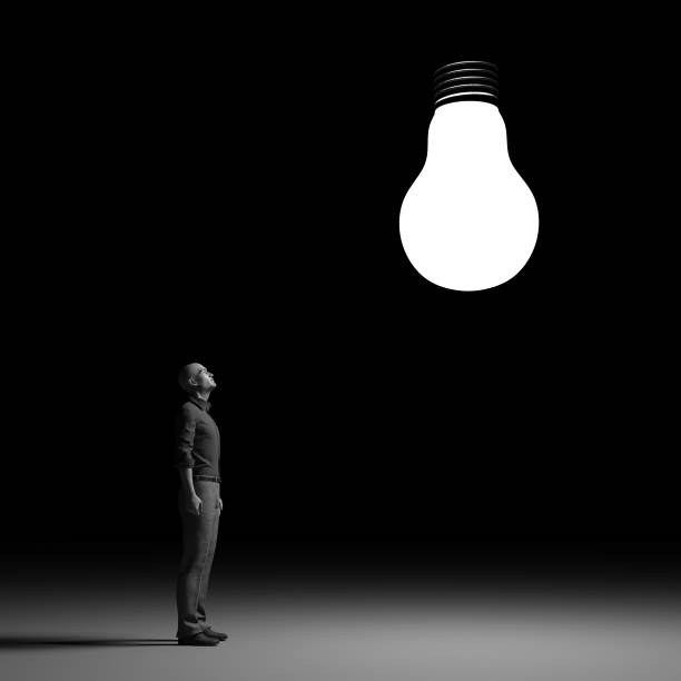 istock The man looks up towards a bright bulb. 825550690