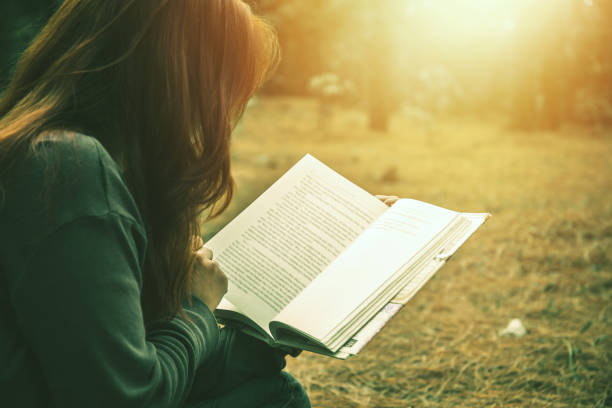 istock Woman relaxing reading in park. holiday 825551638