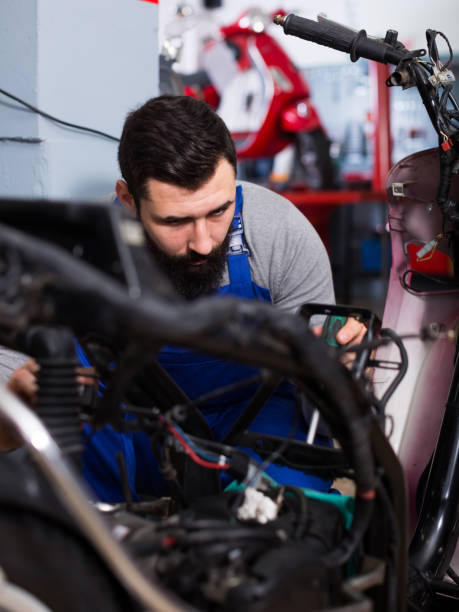 istock Worker repairing motorbike 825554194