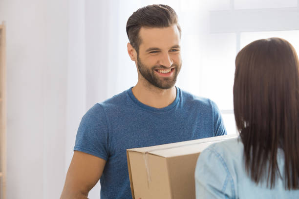 istock Young couple moving to a new apartment together relocation 825554578