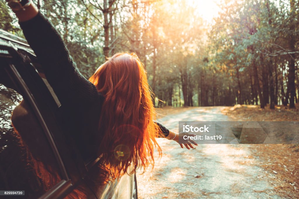 Woman driving a car traveling happily. Independence - Concept Stock Photo