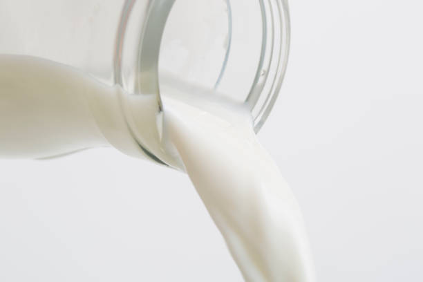 istock Pouring Milk From a Glass bottle. 825554944