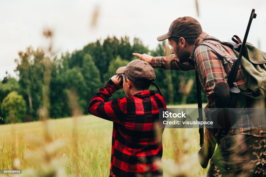 Father and Son hunting for boar Real hunter, northern Europe Hunting - Sport Stock Photo