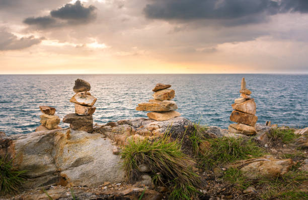 istock Stacked stones on a beach in Thailand at sunset 825561810