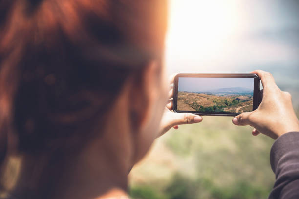 istock Woman hand using mobile phone photo. Mountain nature 825561952