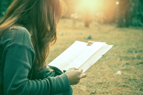 istock Woman relaxing reading in park. holiday 825562272