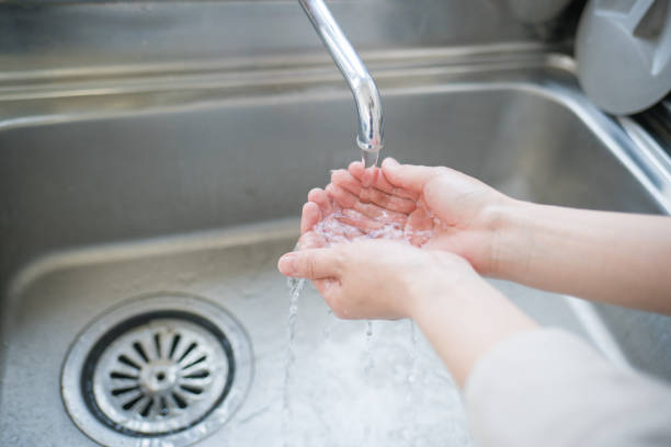 istock Woman washing her hands 825562510