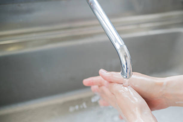 istock Woman washing her hands 825562792