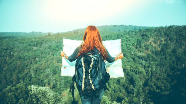 istock Travelers explore the mountainous forest map. 825565468
