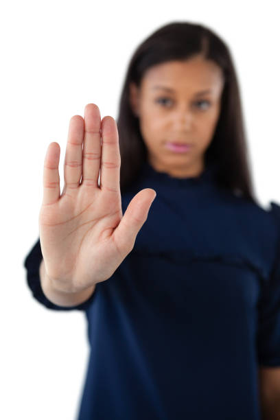 istock Serious female executive showing stop sign 825569104