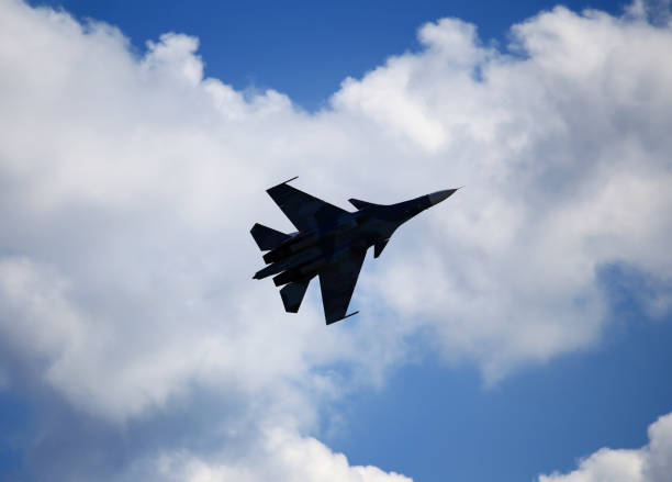 istock Fighter in the sky against the background of clouds 825573034