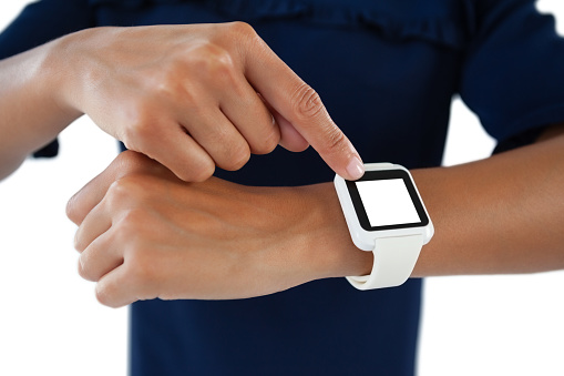 Close-up of female executive operating her smartwatch