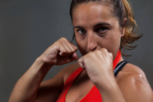 istock Determined woman practicing boxing in fitness studio 825574312