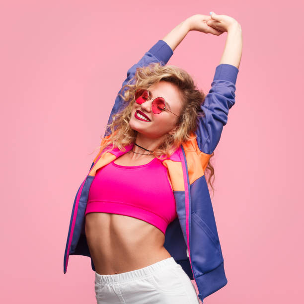 istock Trendy woman stretching up on pink 825577362