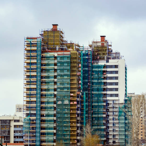 istock Construction of multistory residential building. Construction work on the building lining insulation. 825580988
