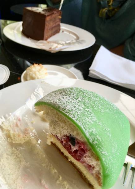 istock Brown and green cakes on the cafe table 825581372
