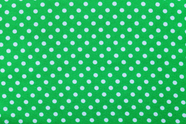 istock Green polka-dot cotton background top view 825584012