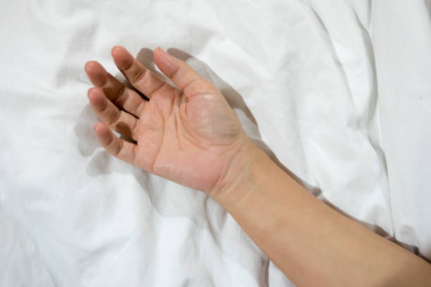 istock girl hand on the bed 825585156