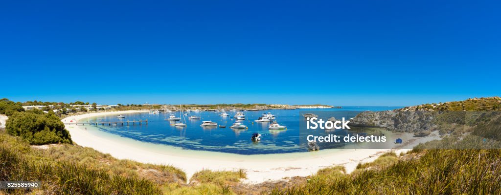 Dreamy Bay, white beach with boat and rocks, island in Indian Ocean, Rottnest Island, Australia, Western Australia, Down Under Panorama of a bay on Rottnest Island with dreamy white beach and boats, bounded by rocks. Island in the Indian Ocean, Australia, Western Australia, Down Under Rottnest Island Stock Photo