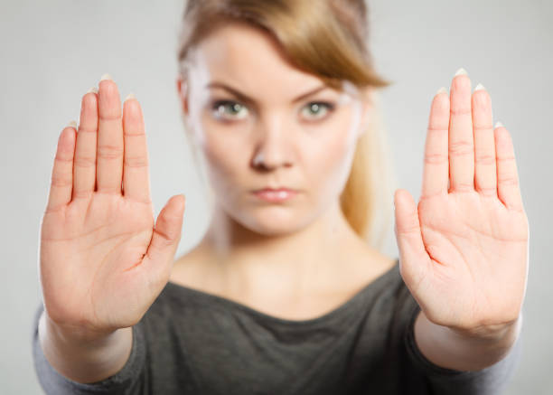 istock Female shows stop sign by her hand. 825586168