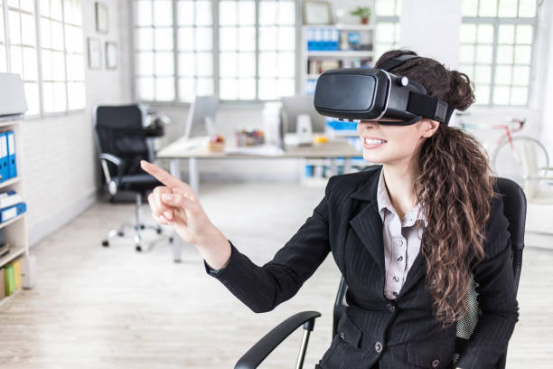 istock Young woman with VR headset in modern office 825587132
