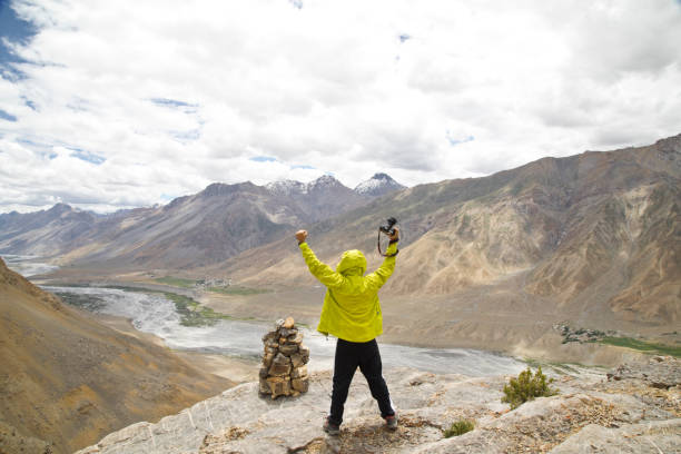 istock Successful photographer holding SLR camera on mountain 825592828