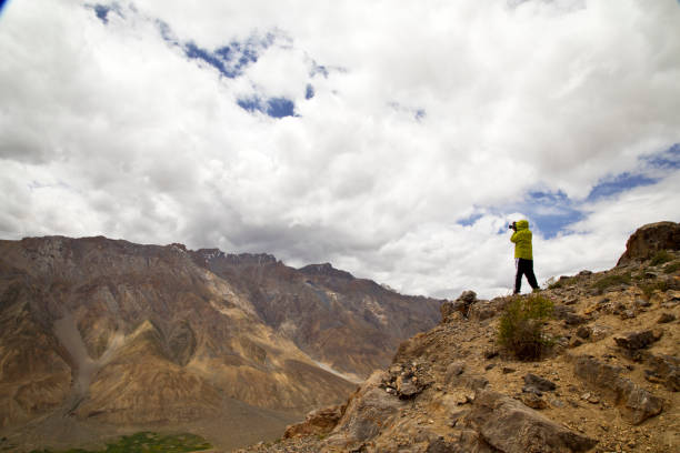 istock Man photographing rocky mountain 825592882