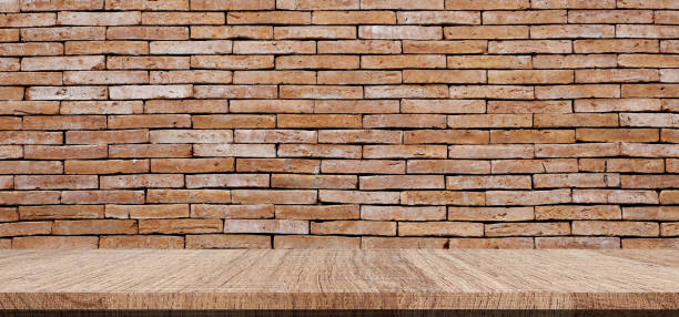 istock Empty wood table over brick wall background, product montage display background 825593576