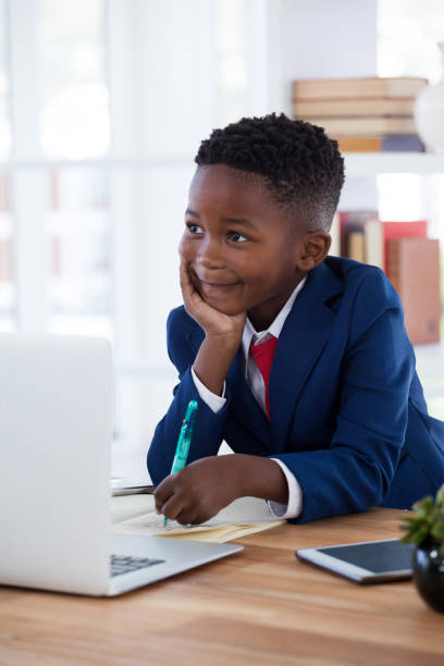 istock Thoughtful businessman with hand on chin looking away while writing n paper 825594338