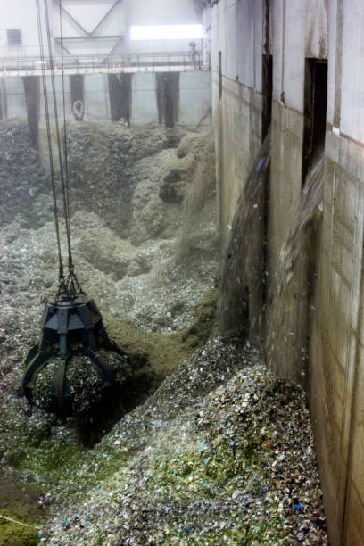 istock Crane manipulator in the garbage factory 825596728