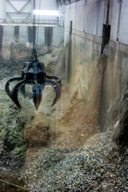 istock Crane manipulator in the garbage factory 825596746