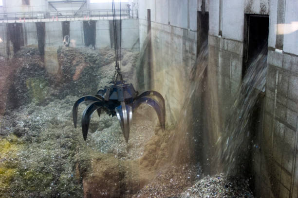 istock Crane manipulator in the garbage factory 825596764