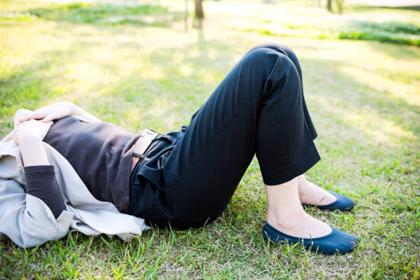 istock Woman lying on the green field 825600762
