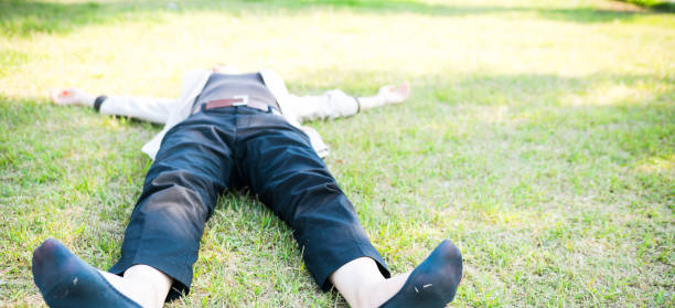 istock Woman lying on the green field 825600878
