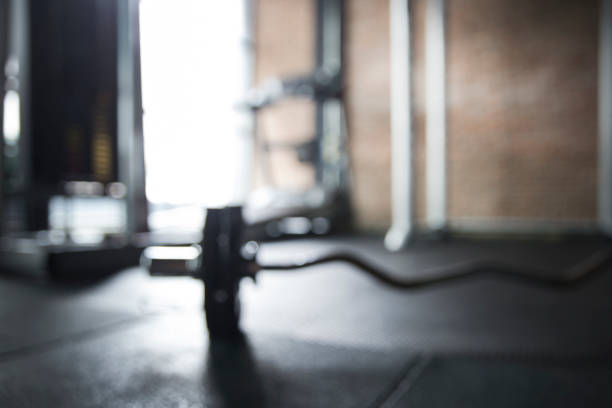 istock Gym background with Blurred of Barbell on the floor 825601452