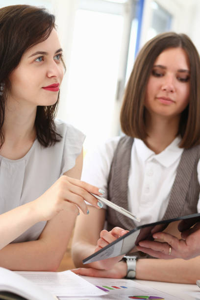 istock Group of people in office look at mobile tablet pc 825604642