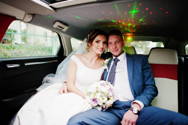 istock Fantastic wedding couple sitting in the limousine. 825604878