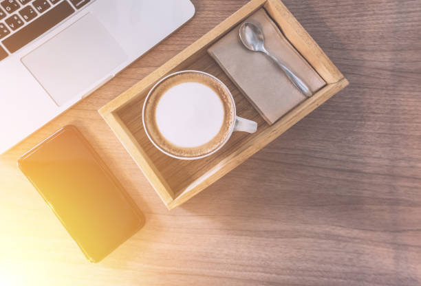 istock Hot Coffee or coffee cappuccino, Sugar, Mobile Phone and laptop computer On the working table in the morning. 825605106