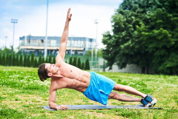 istock Shirtless man exercising at the park 825606438