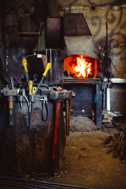 istock Fire in the furnace in the smithy, tools 825607978