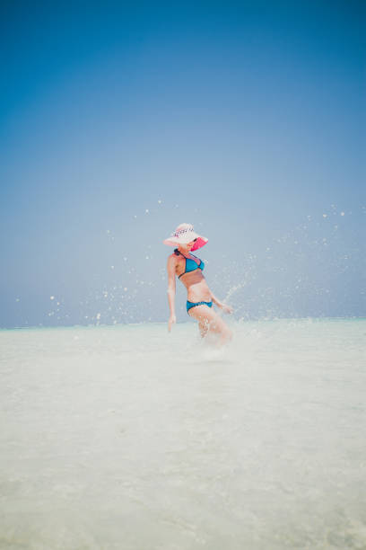 istock Woman jumping on the beach, Maldives 825612446