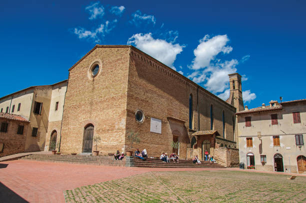 вид на церковь сант'агостино с людьми в сан-гиминьяно - italy bell tower built structure building exterior стоковые фото и изображения